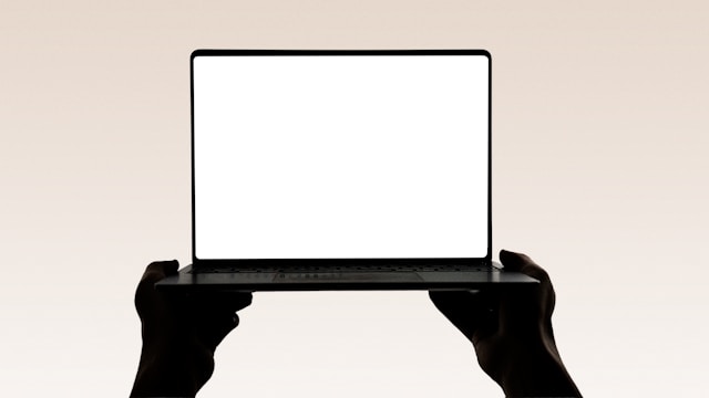 A laptop held in the air