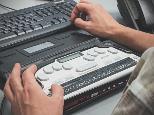 A person using a braille writer