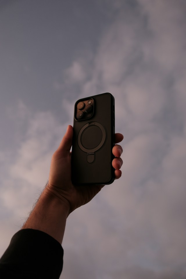 A phone held up against the sky