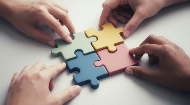 People putting puzzle pieces together